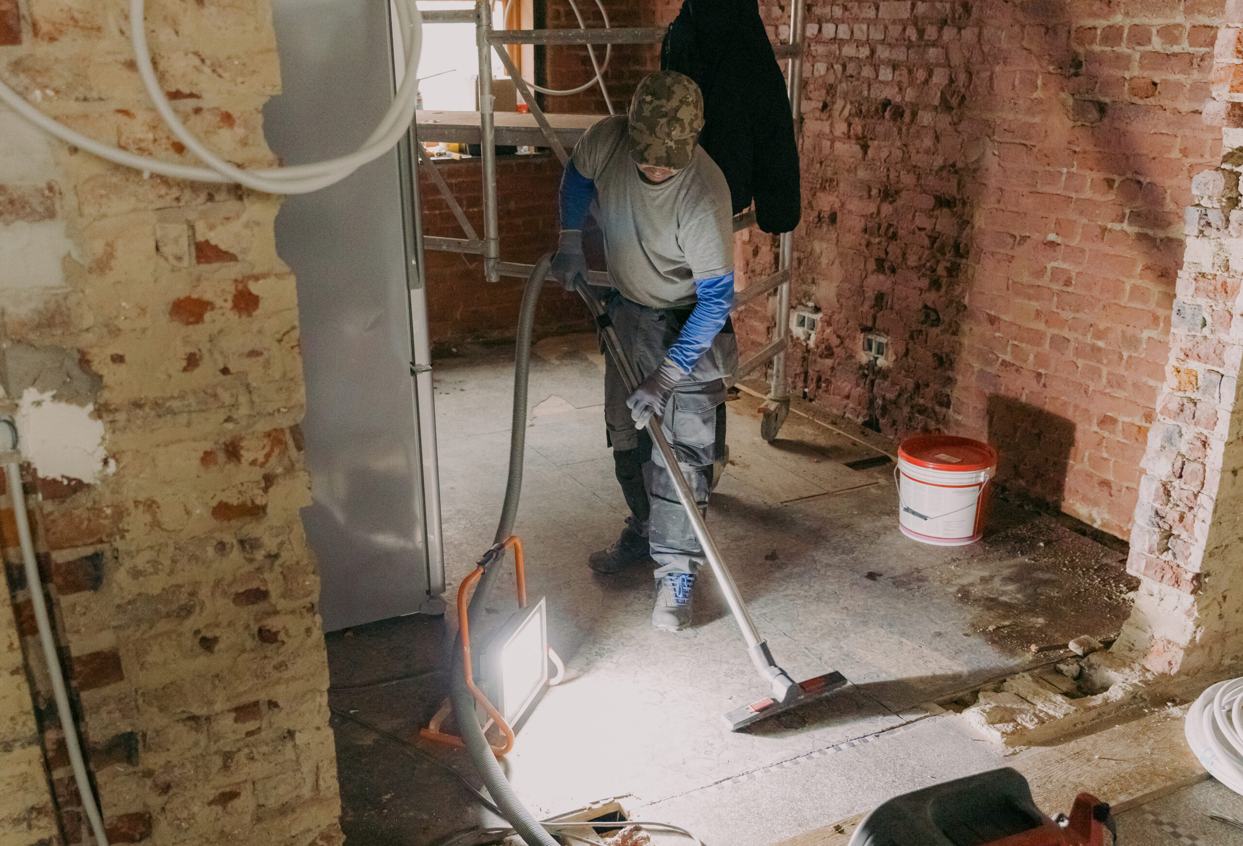 young-man-vacuums-landing-repair-room